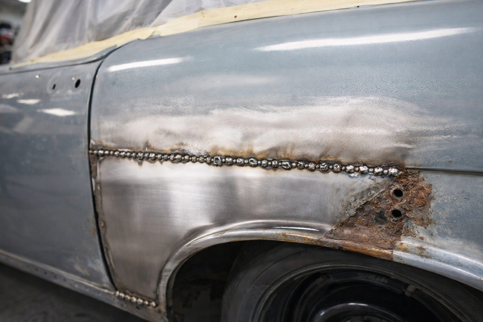 Rust cut-out section with fresh metal welded in